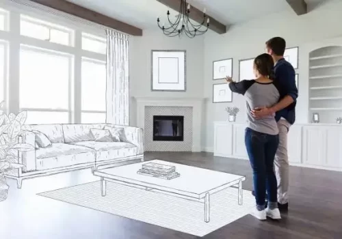 A young couple stand in the empty living room of their new home and imagine the room decor and furniture placement.